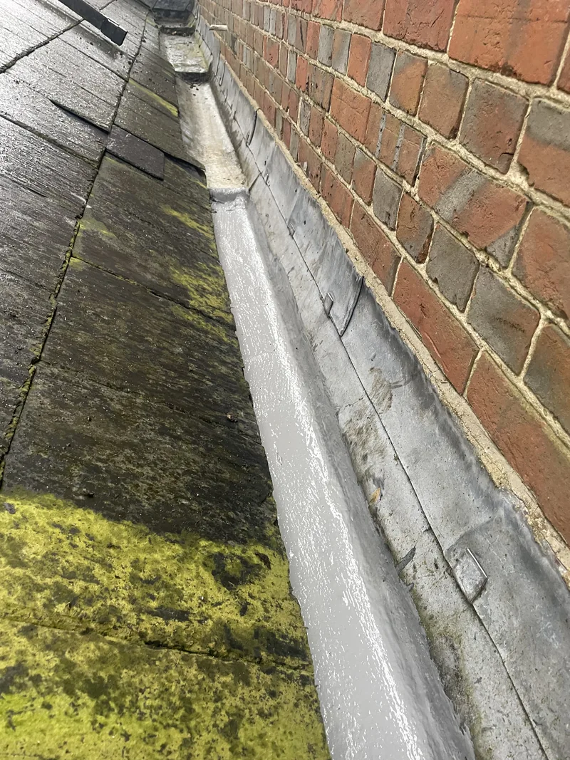 The same channel beside brickwork with accumulated debris removed