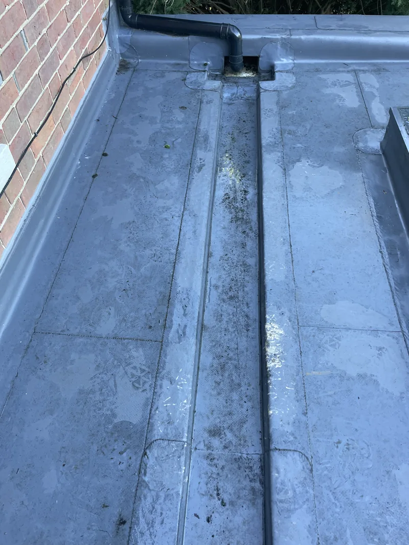The same lead-lined box gutter following clearance, with the channel exposed
